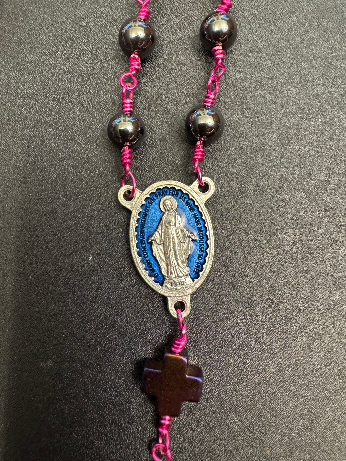 Blue miraculous medal centerpiece on full size rosary with hematite beads and fuchsia colored wire