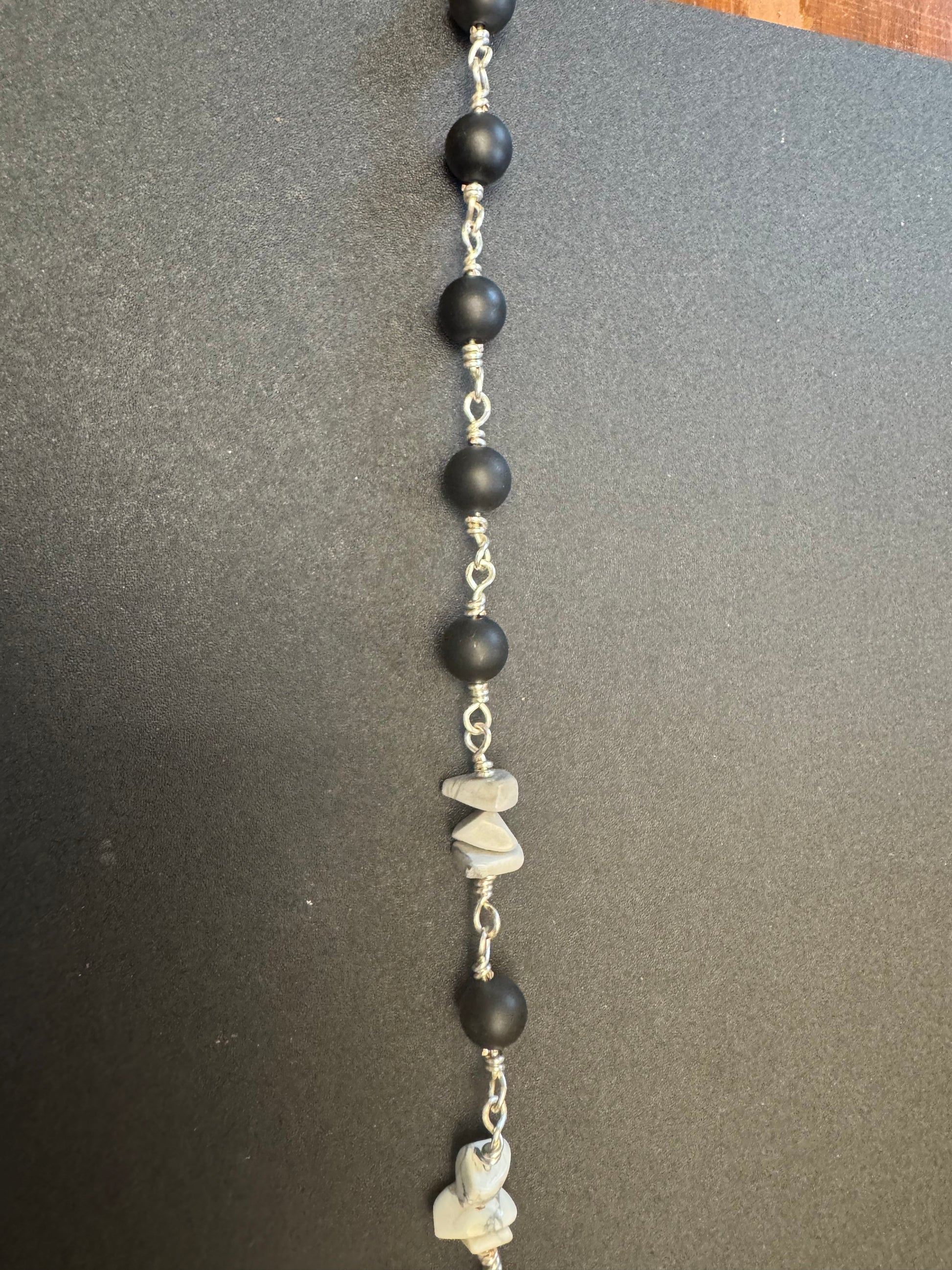 Closeup of St. Bridget pocket rosary With black matte beads