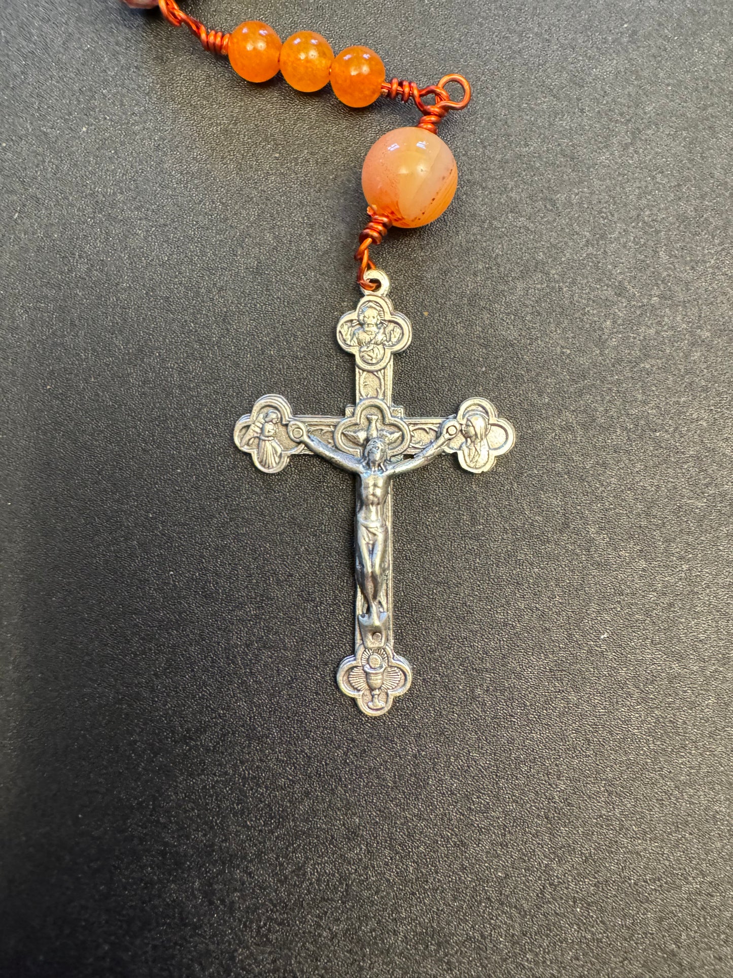 Crucifix on single decade our lady of Guadalupe rosary with green and orange swirl glass beads and orange colored wire