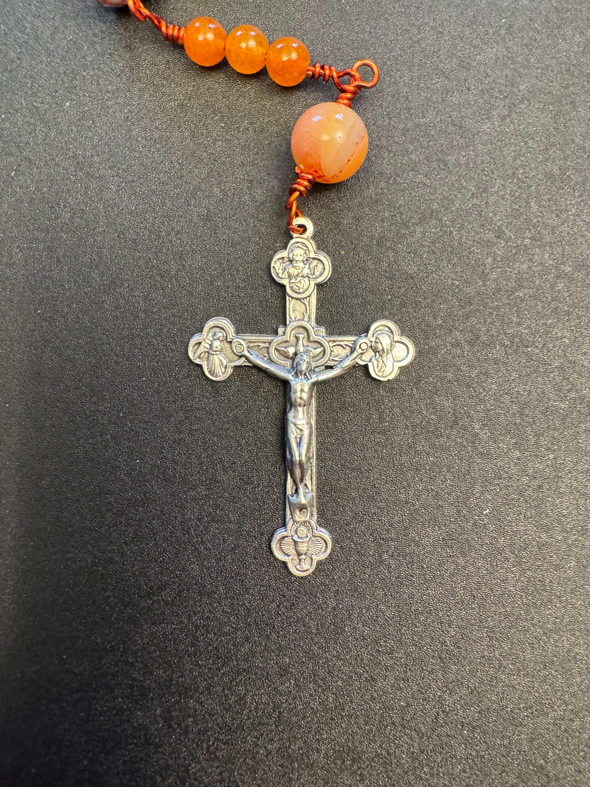 Crucifix on single decade our lady of Guadalupe rosary with green and orange swirl glass beads and orange colored wire