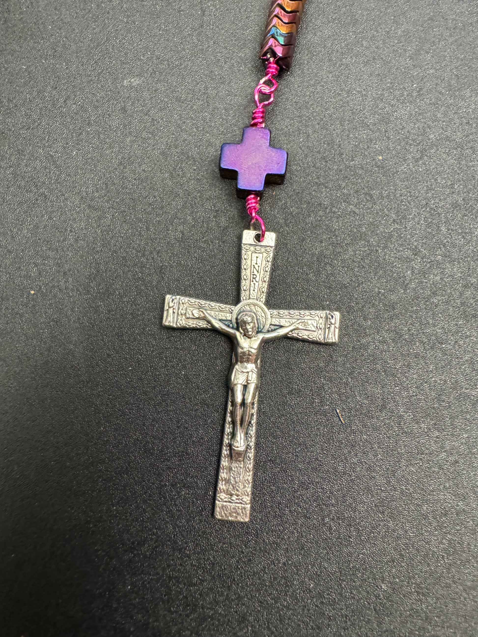 Crucifix on full size rosary with hematite beads and fuchsia colored wire and miraculous medal centerpiece