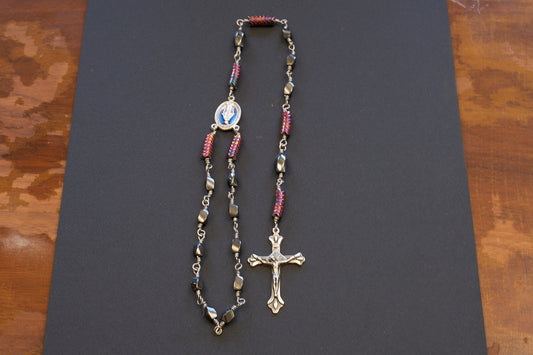 single decade rosary with oval faceted hematite beads and blue miraculous medal centerpiece