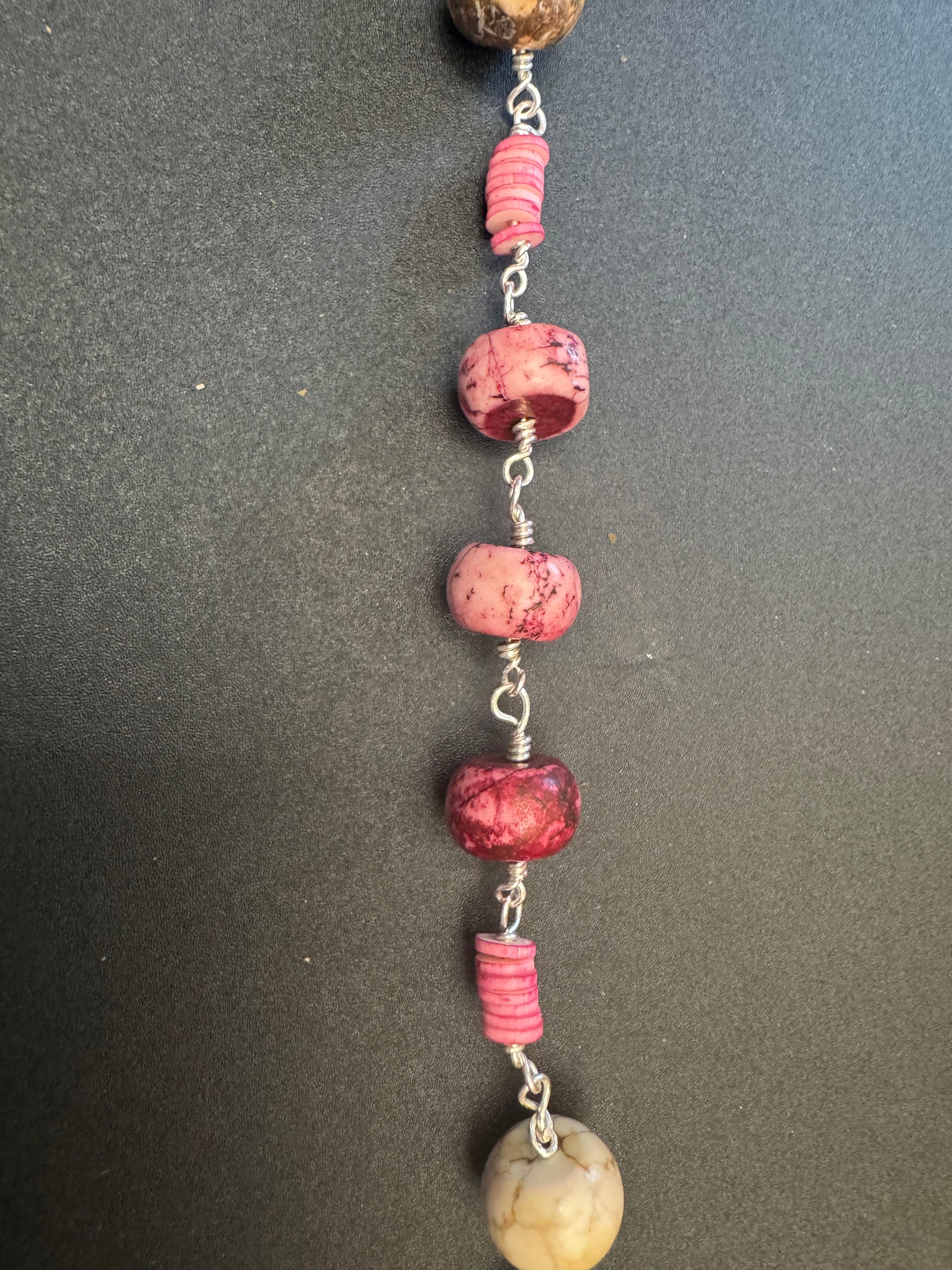 Closeup of St. Jude Single Decade Rosary With pink stone beads and green accented centerpiece