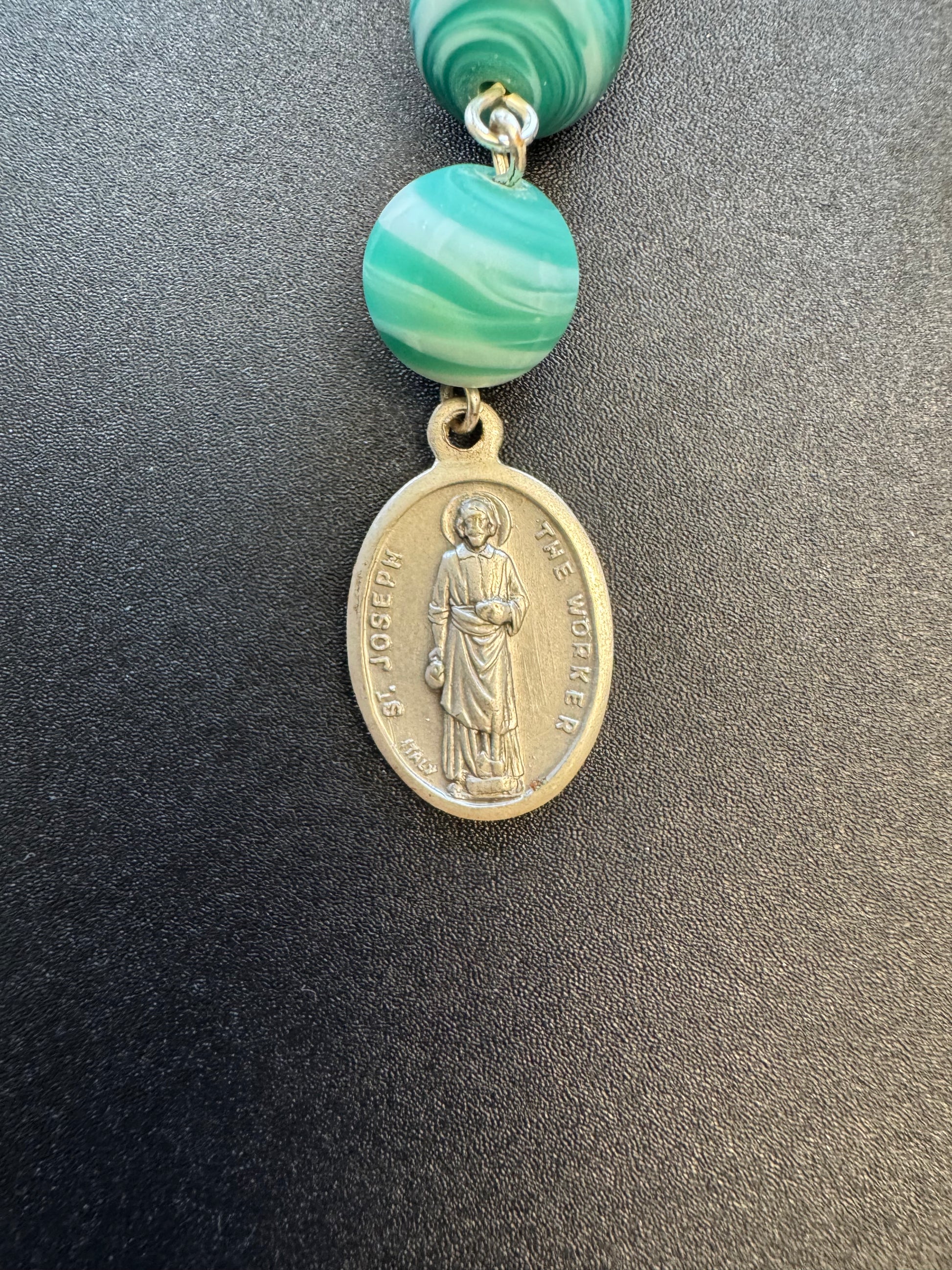 St. Joseph the worker medal on pocket rosary with blue and white swirl beads