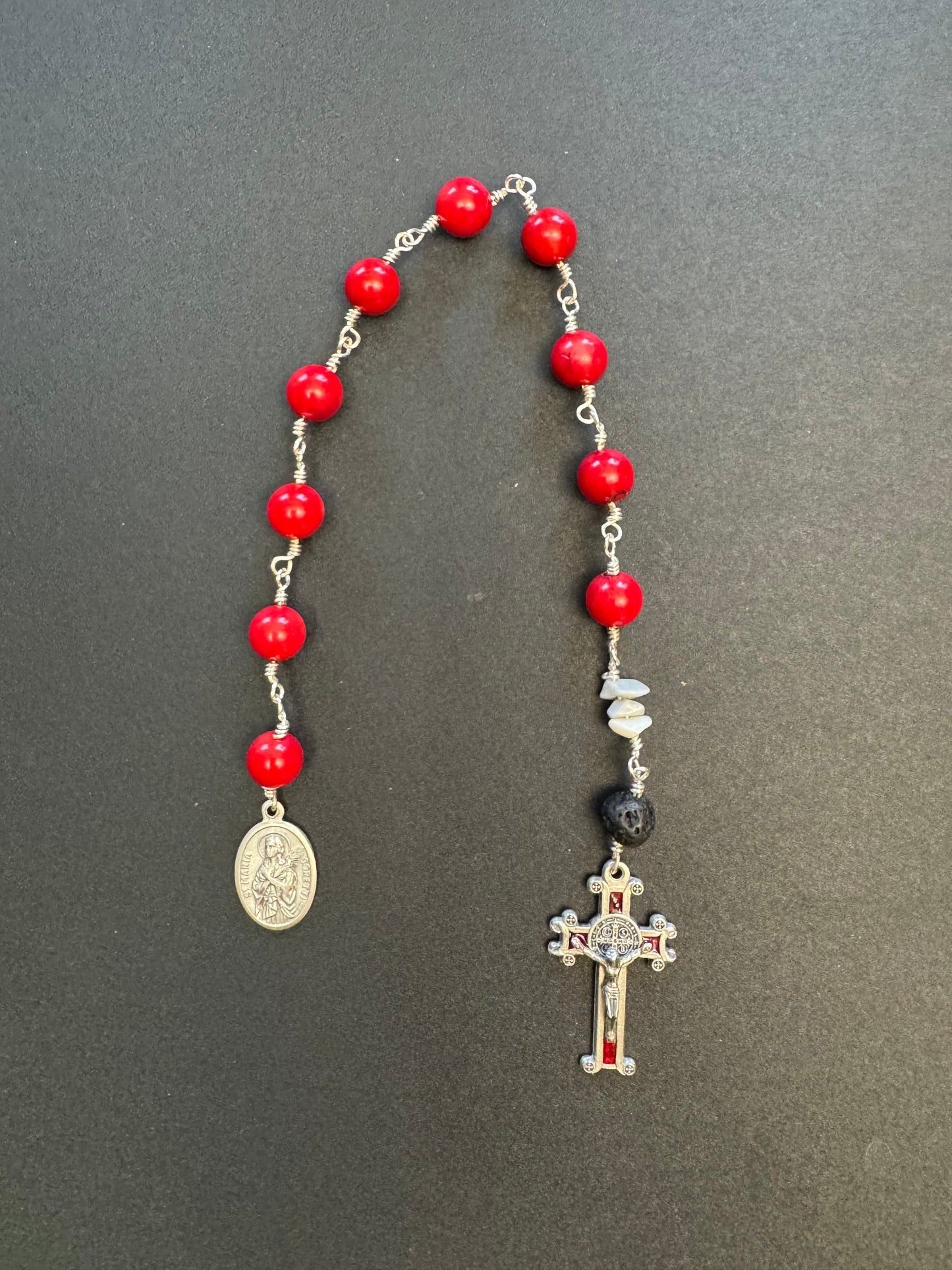 Top-down view of St. Maria Goretti red stone bead pocket rosary