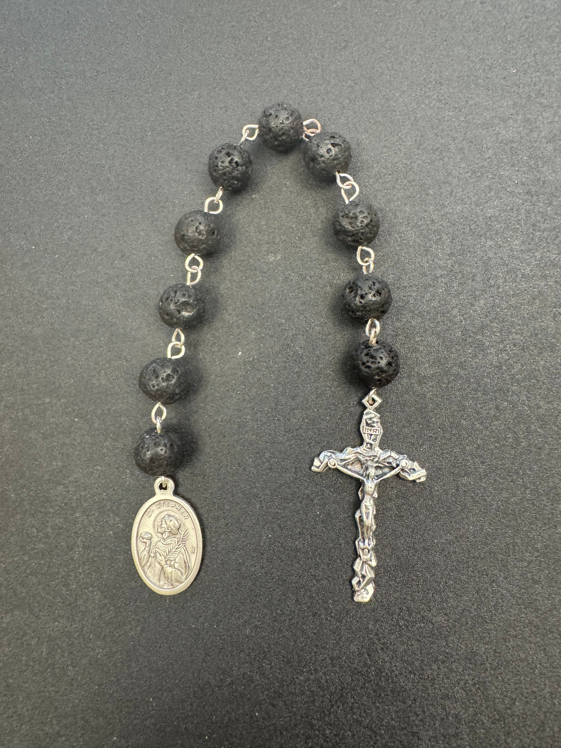 Top down view of St. Stephen Pocket Rosary with black lava beads