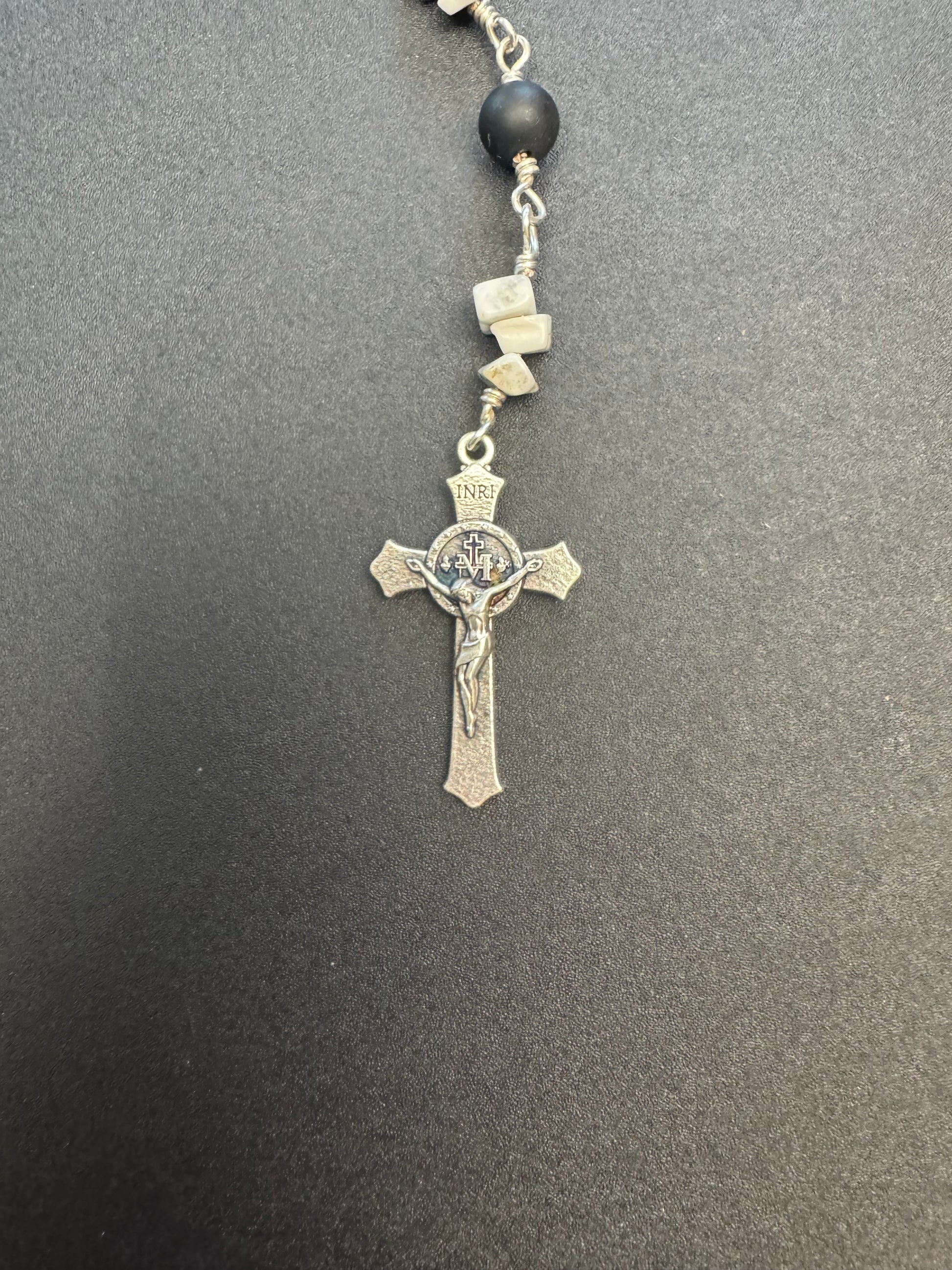 Crucifix on full size rosary with gray and black stone beads