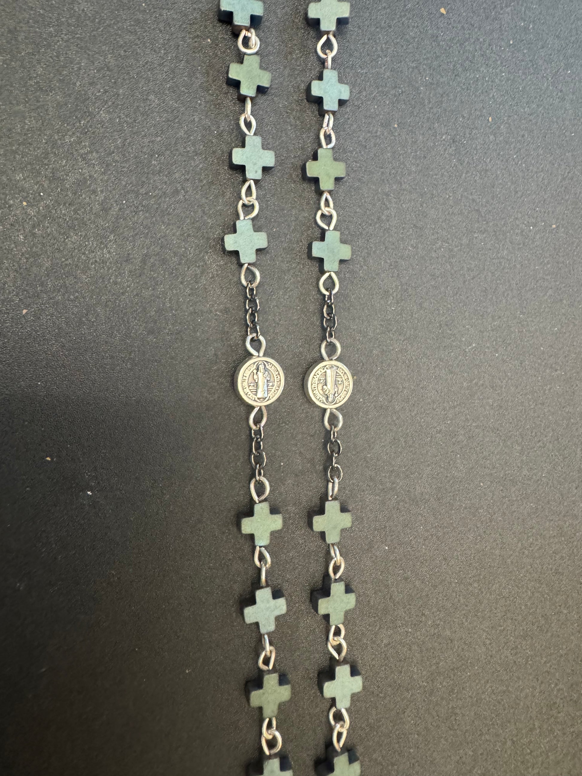 Closeup of full size rosary with frosted hematite cross beads and st. Benedict medal beads