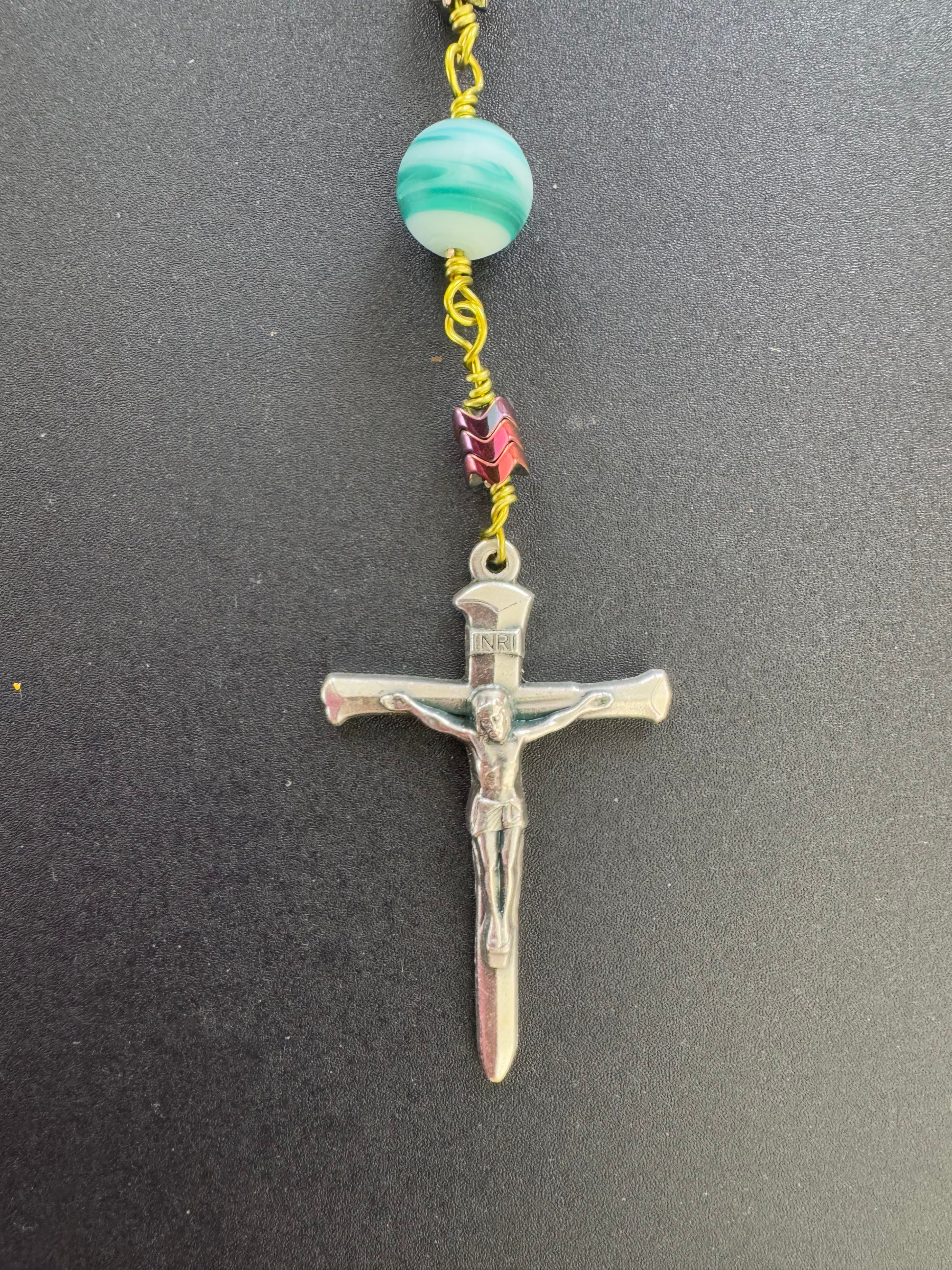 crucifix on hematite rosary with green wire