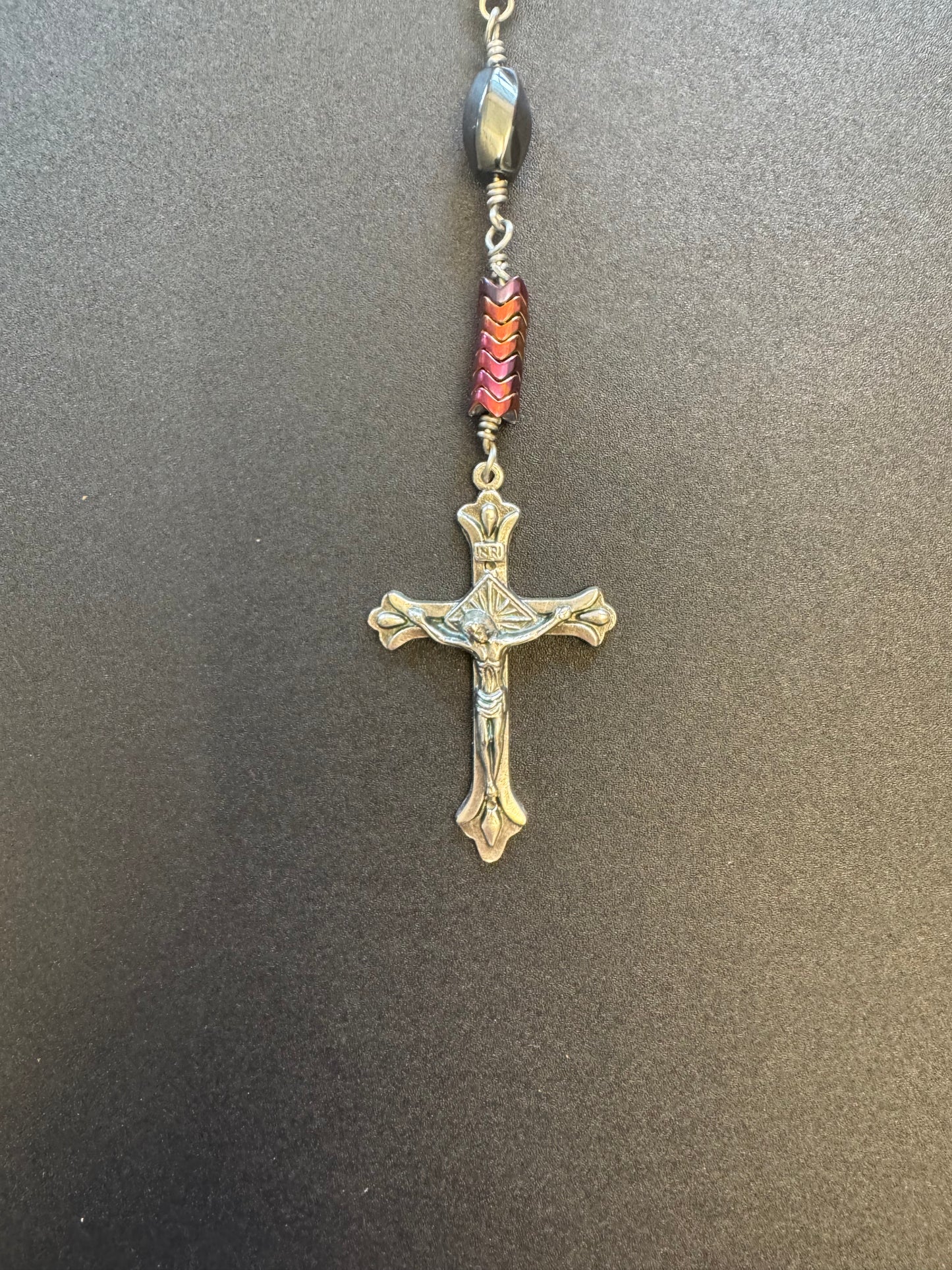 Crucifix on single decade rosary with oval faceted hematite beads and blue miraculous medal centerpiece