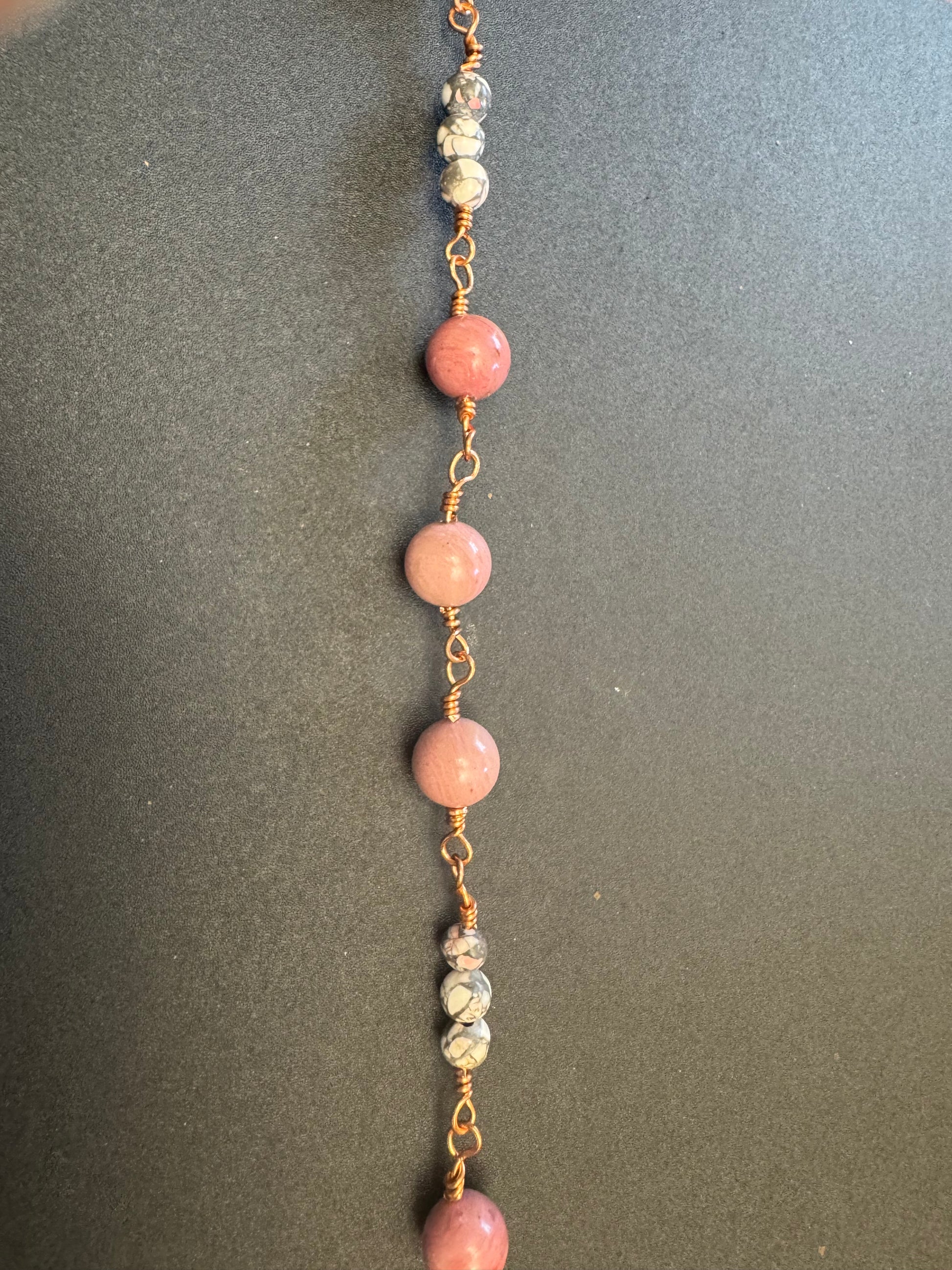 Closeup of St. Maria Goretti Single Decade Rosary with pink stone beads and wooden crucifix
