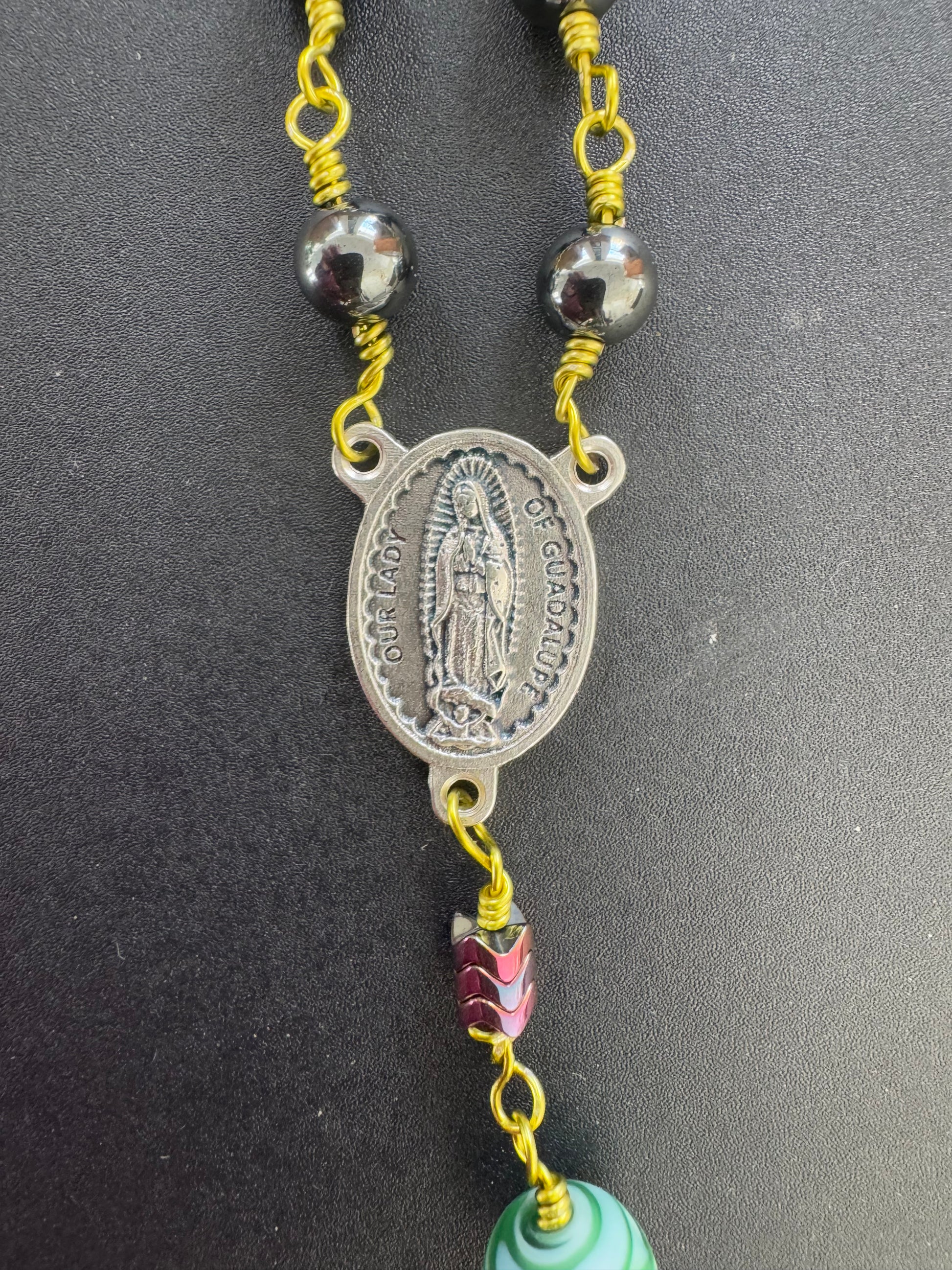 our lady of guadalupe medal on hematite rosary with green wire