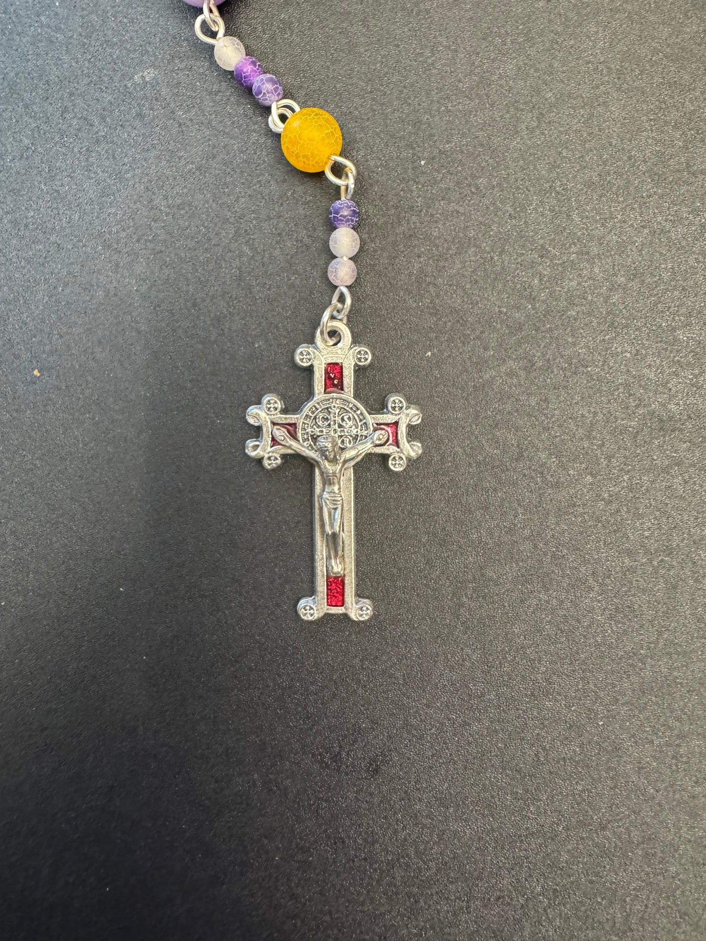 red crucifix on orange and purple frosted bead rosary