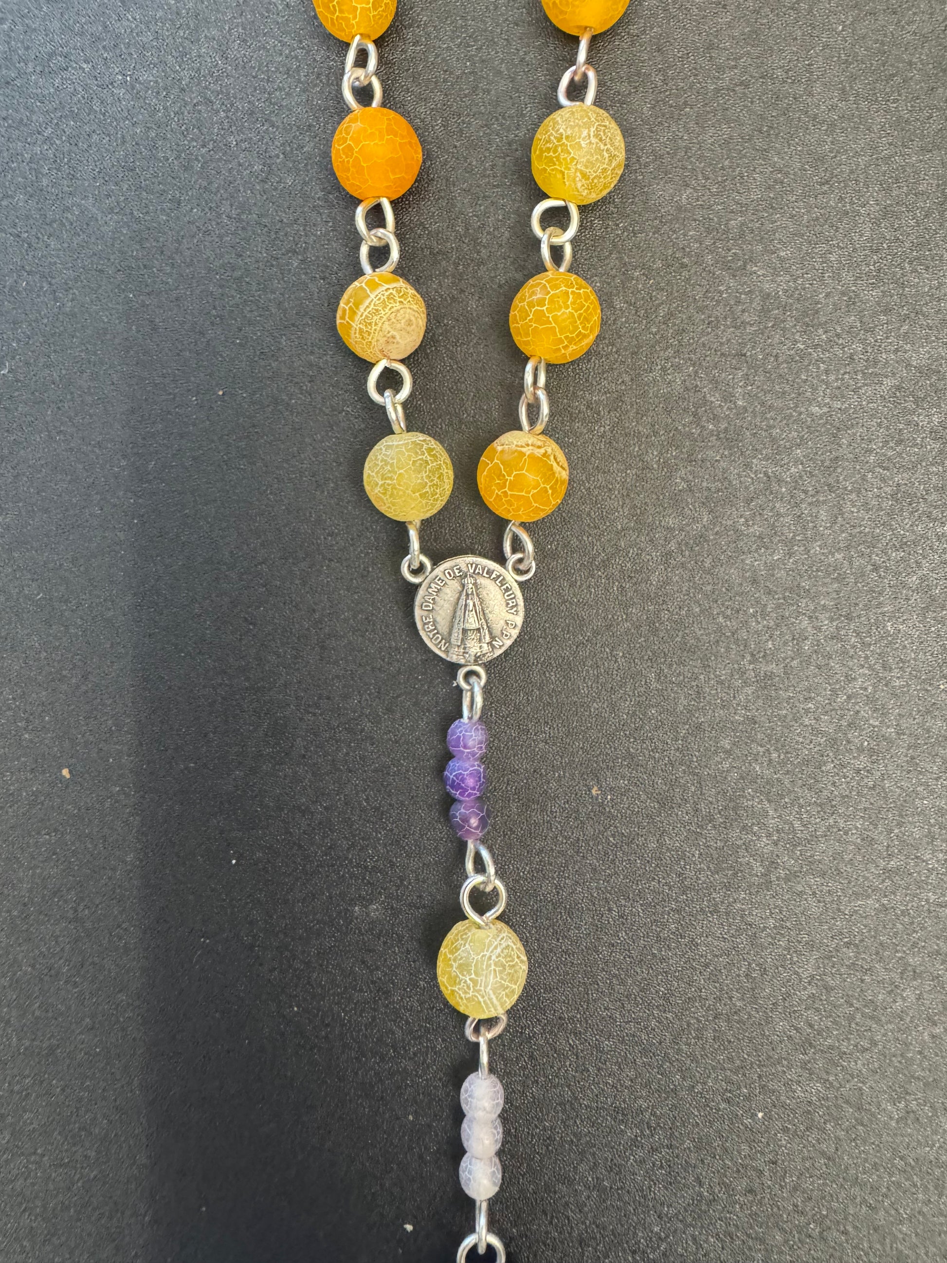 centerpiece on orange and purple frosted bead rosary